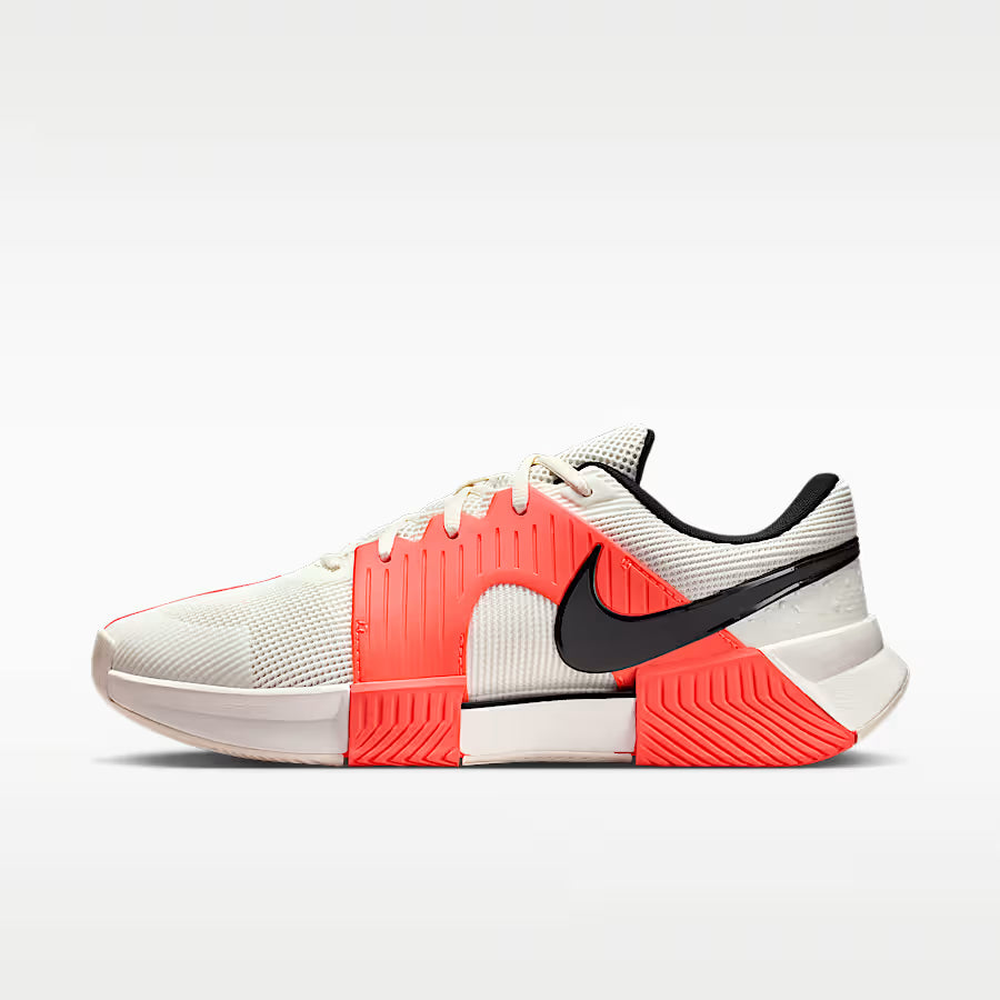 White and red athletic shoe with black swoosh logo on a white background
