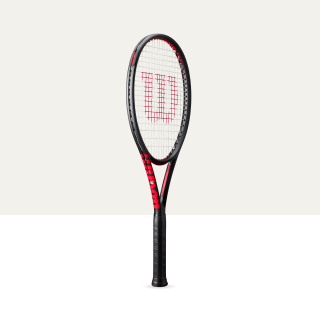 Tennis racket with a red Wilson logo on a light gray background
