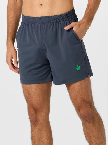 Person wearing navy shorts with a green leaf logo on a white background